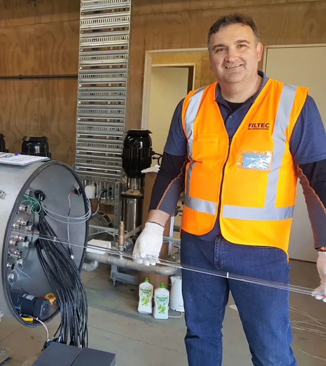 FILTEC water treatment service technician performing maintenance